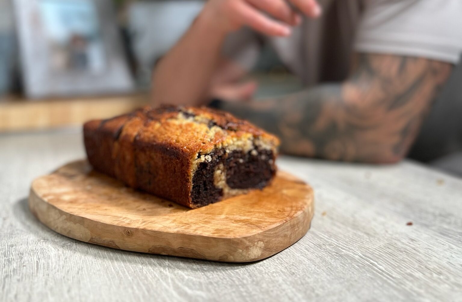 Loaf of marble chocolate and banana bread served on a wooden chopping board